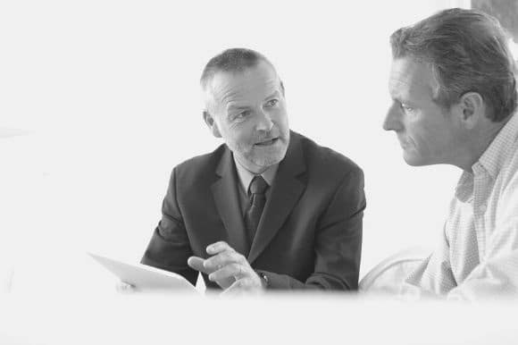 An accounts receivable clerk going over numbers with a colleague.