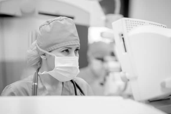 Anesthesiologist monitoring a patient's vital signs.