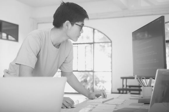 A manager checks on job applicants as part of his company's applicant tracking process.