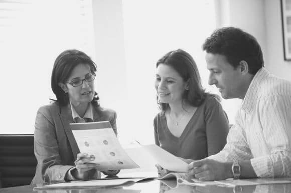 A financial consultant goes over financial strategies with her clients.