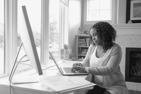 Woman working at home on a laptop computer.