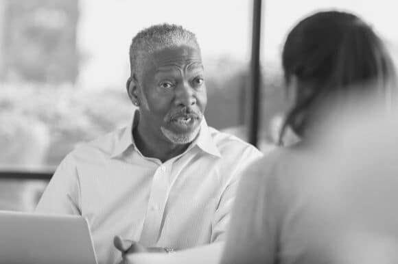 Manager addressing poor work performance with employee in office