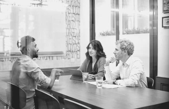 A team conducts a peer interview.