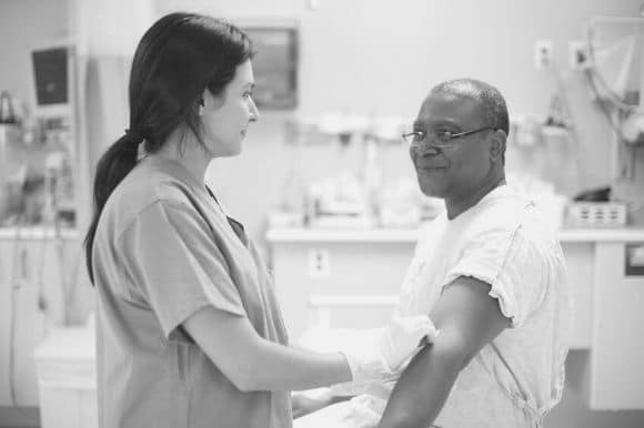 Phlebotomist working with patient in medical office