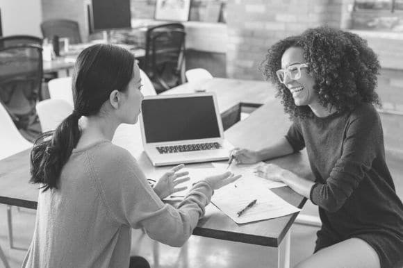 A purchasing agent works with her colleague.