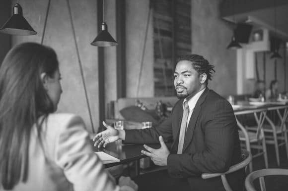 Recruiting coordinator talking with candidate in coffee shop