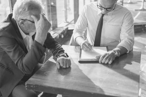 Staff accountant crunches numbers with a colleague.