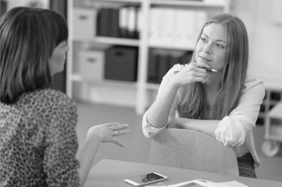 two women having a conversation at work