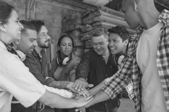 Union members showing solidarity by joining hands in a circle.