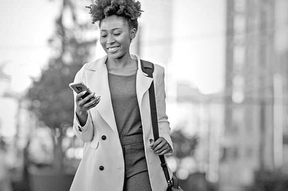 A woman uses her phone to apply to jobs.