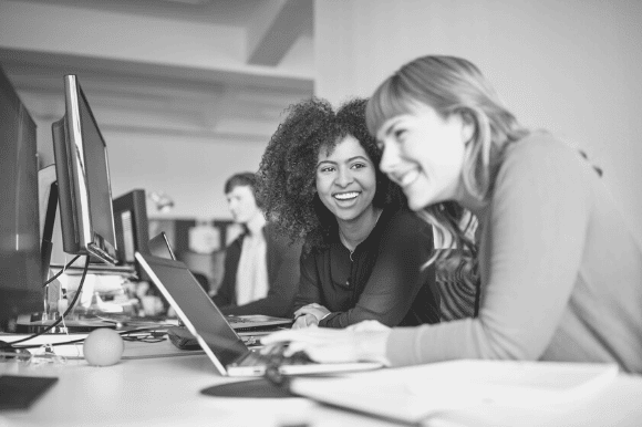 Technical support specialist helping a colleague with a computer issue.